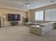 Gathering room with sectional sofa, large TV, and ceiling fan at 1404 Crystal Rainey Ave, North Las Vegas, NV 89086