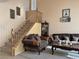 Living room with hardwood floors, comfortable seating, and a staircase at 1404 Crystal Rainey Ave, North Las Vegas, NV 89086