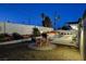 Mid-century modern backyard with pool, patio furniture, and desert landscaping at night at 1558 Aztec Way, Las Vegas, NV 89169