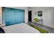 Bright bedroom with light walls and blue curtains at 1558 Aztec Way, Las Vegas, NV 89169