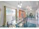 Mid-century modern dining room with glass table and orange doors at 1558 Aztec Way, Las Vegas, NV 89169