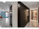 Mid-century modern hallway with sleek dark doors and polished concrete floors at 1558 Aztec Way, Las Vegas, NV 89169