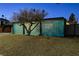 Midcentury modern home with a unique blue block wall facade at night at 1558 Aztec Way, Las Vegas, NV 89169