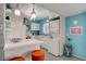 Retro kitchen with white cabinets, stacked washer and dryer at 1558 Aztec Way, Las Vegas, NV 89169