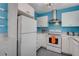 Retro-style kitchen with white cabinets and blue backsplash at 1558 Aztec Way, Las Vegas, NV 89169