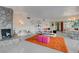 Mid-century modern living room with fireplace and orange rug at 1558 Aztec Way, Las Vegas, NV 89169