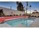 Relaxing turquoise pool with coral-colored tile and a mid-century modern aesthetic at 1558 Aztec Way, Las Vegas, NV 89169