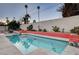 Modern rectangular pool with coral-colored tile and a mid-century modern aesthetic at 1558 Aztec Way, Las Vegas, NV 89169