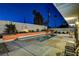 Inviting turquoise pool surrounded by a modern patio at night at 1558 Aztec Way, Las Vegas, NV 89169