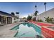 Long view of a refreshing turquoise pool with a mid-century modern design at 1558 Aztec Way, Las Vegas, NV 89169