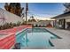 Stunning turquoise pool with coral-colored tile and a mid-century modern design at 1558 Aztec Way, Las Vegas, NV 89169