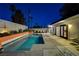 Night view of a refreshing turquoise pool with a sleek mid-century modern design at 1558 Aztec Way, Las Vegas, NV 89169