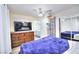 Main bedroom with dresser, large TV and en-suite bathroom at 1574 Teardrop St, Las Vegas, NV 89142