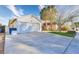 Exterior view of a house with an attached garage and a concrete driveway at 1574 Teardrop St, Las Vegas, NV 89142