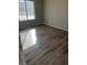 Bright bedroom featuring wood-look floors and large window at 2072 Mesquite Ln # 104, Laughlin, NV 89029