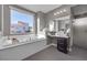 Modern bathroom with soaking tub and a large window at 232 Errogie St, Henderson, NV 89012