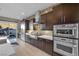 Modern kitchen with stainless steel appliances and dark wood cabinetry at 232 Errogie St, Henderson, NV 89012