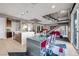 Modern kitchen with island and breakfast bar opens to dining area with glass table and red chairs at 232 Errogie St, Henderson, NV 89012