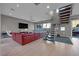 Open living area with a red sectional sofa and a view of modern staircase at 232 Errogie St, Henderson, NV 89012