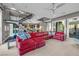 Spacious living area featuring a red sectional sofa and modern staircase at 232 Errogie St, Henderson, NV 89012