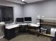 Home office with L-shaped desk, multiple monitors, and built-in shelving at 232 Errogie St, Henderson, NV 89012