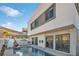 View of home's exterior, highlighting the pool and patio area at 232 Errogie St, Henderson, NV 89012