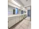 Double vanity bathroom with a window and mirrored closet at 2386 Pickwick Dr, Henderson, NV 89014