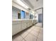 Double vanity bathroom with a window and mirrored closet at 2386 Pickwick Dr, Henderson, NV 89014