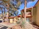 Attractive condo building with landscaping and trees at 2386 Pickwick Dr, Henderson, NV 89014