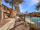 Community pool area with walkway and black fence at 2386 Pickwick Dr, Henderson, NV 89014