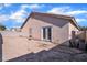 Large backyard with gravel and a patio at 2419 Country Valley Ct, North Las Vegas, NV 89030