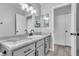 Bathroom with gray vanity, white sink, and marble-look countertop at 2419 Country Valley Ct, North Las Vegas, NV 89030