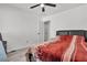 Bedroom with red blanket, ceiling fan and a gray nightstand at 2419 Country Valley Ct, North Las Vegas, NV 89030