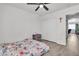 Bedroom with floral bedding, ceiling fan and gray nightstand at 2419 Country Valley Ct, North Las Vegas, NV 89030