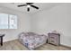 Bedroom with floral bedding, ceiling fan and gray nightstand at 2419 Country Valley Ct, North Las Vegas, NV 89030