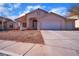 Single-story house with a two-car garage and desert landscaping at 2419 Country Valley Ct, North Las Vegas, NV 89030