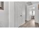 Bright hallway with white doors and wood-look flooring at 2419 Country Valley Ct, North Las Vegas, NV 89030