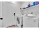 Laundry room with washer, dryer, and shelving at 2419 Country Valley Ct, North Las Vegas, NV 89030