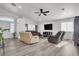 Spacious living room with hardwood floors and a ceiling fan at 2419 Country Valley Ct, North Las Vegas, NV 89030