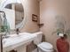 Elegant bathroom with pedestal sink, toilet, and decorative accents at 2521 Seascape Dr, Las Vegas, NV 89128