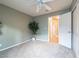 Bright bedroom with ceiling fan, access to hallway, and ample closet space at 2521 Seascape Dr, Las Vegas, NV 89128