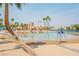 Resort-style pool with sandy beach entry and palm trees at 2521 Seascape Dr, Las Vegas, NV 89128