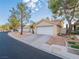 Two-story tan stucco home with a two-car garage at 2521 Seascape Dr, Las Vegas, NV 89128