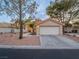 Tan stucco home with a two-car garage at 2521 Seascape Dr, Las Vegas, NV 89128