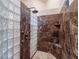 Large walk-in shower with glass block accents and marble tile at 2521 Seascape Dr, Las Vegas, NV 89128