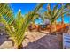 Landscaped backyard with brick patio and palm trees at 2608 Spear St, North Las Vegas, NV 89030