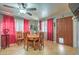 Bright dining area with a wooden table and red curtains at 2608 Spear St, North Las Vegas, NV 89030