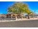 Charming single story home with a lush green tree in the front yard at 2608 Spear St, North Las Vegas, NV 89030