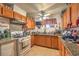 Kitchen with wood cabinets, granite countertops, and stainless steel appliances at 2608 Spear St, North Las Vegas, NV 89030