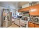 Kitchen boasts stainless steel refrigerator and ample wood cabinets at 2608 Spear St, North Las Vegas, NV 89030